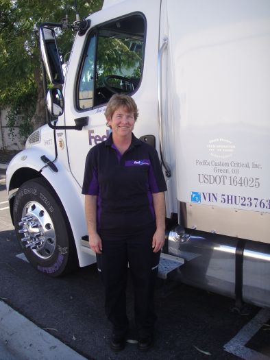 Linda_standing_beside_truck_on_ground.JPG